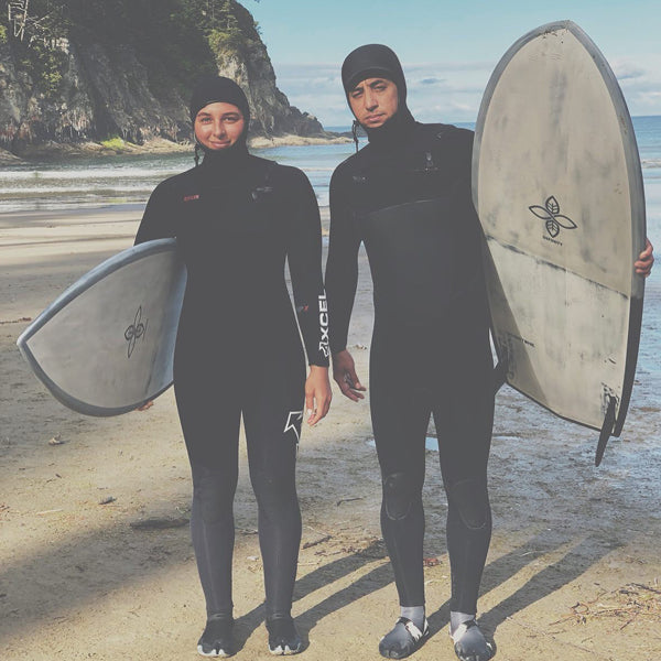 Surfers Izzi Gomez and Dave Boehne holding their Infinity Surfboards 